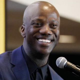 Shaun Harper at a microphone