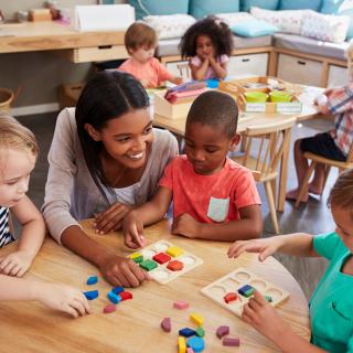 teacher with young students at preschool