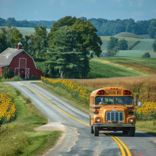 school bus driving down country road